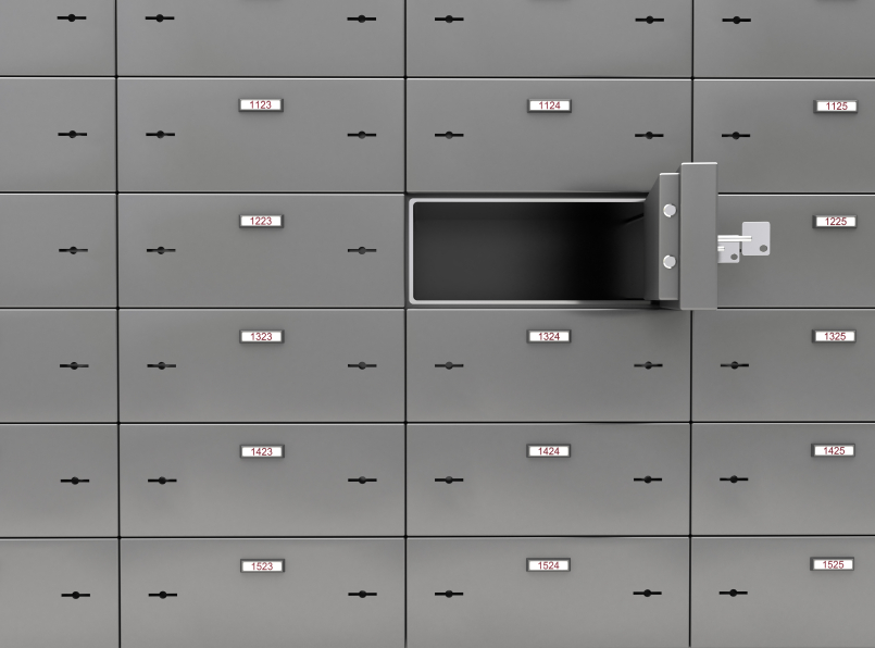 A wall of bank safe deposit boxes with one drawer open